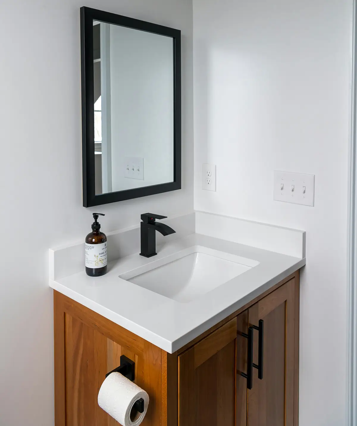 A very clean-looking bathroom sink and mirror