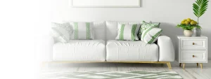 A lounge with white couch, indoor plants and side table, all looking clean and tidy